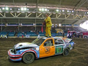 Son Ehren, a firefighter, receiving the trophy on for winning the Burn Institute Demolition Derby in a car sponsored by Woof'n Rose Winery at the San Diego County Fair.